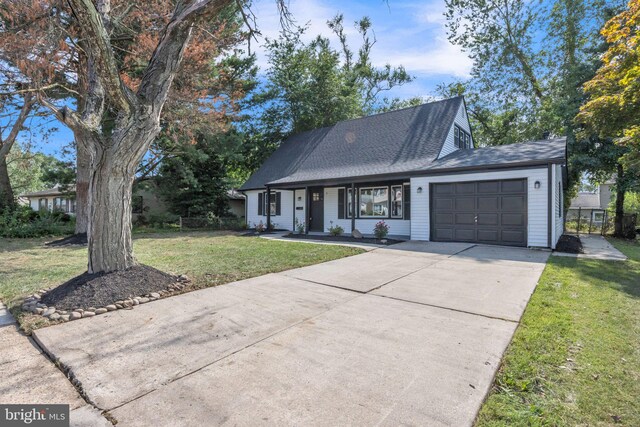 view of front of home with a garage and a front yard