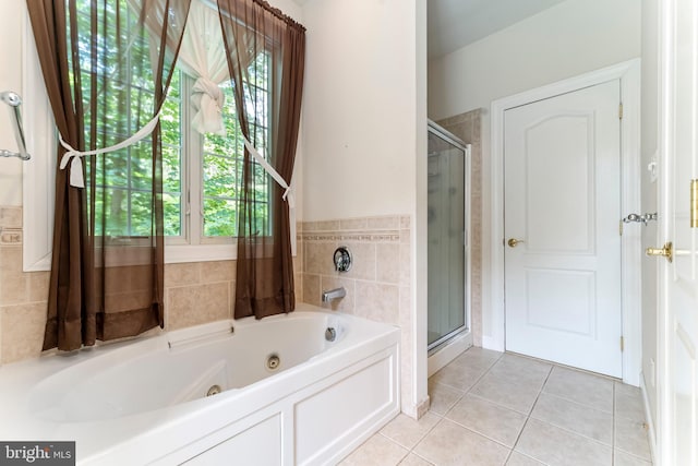 bathroom with plus walk in shower, plenty of natural light, and tile patterned floors