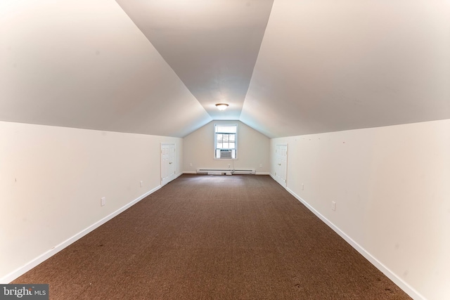 bonus room with dark carpet, vaulted ceiling, and baseboard heating