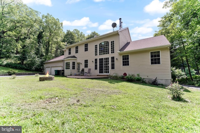 back of property featuring an outdoor fire pit and a yard