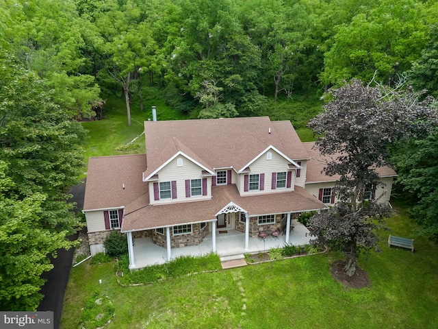 view of front of house with a front lawn and a patio