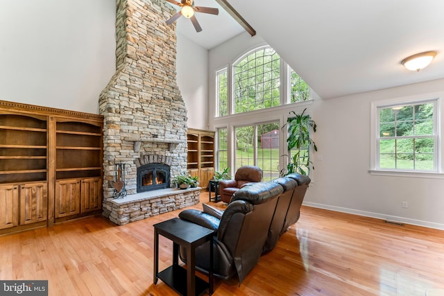 living room with a healthy amount of sunlight, a fireplace, and light wood-type flooring