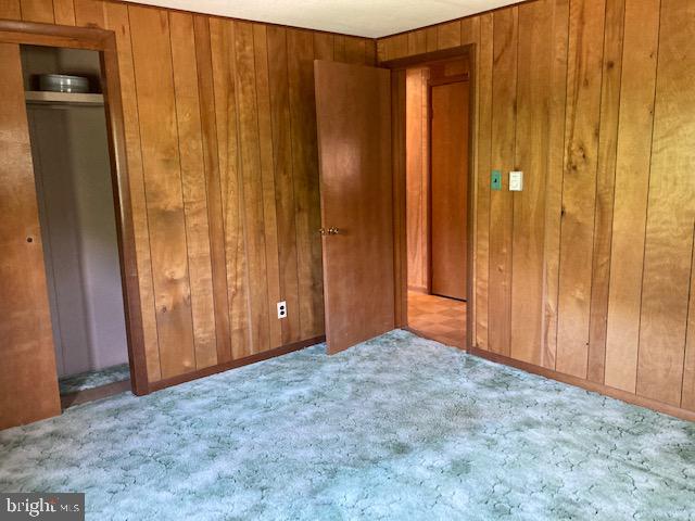 empty room featuring wood walls