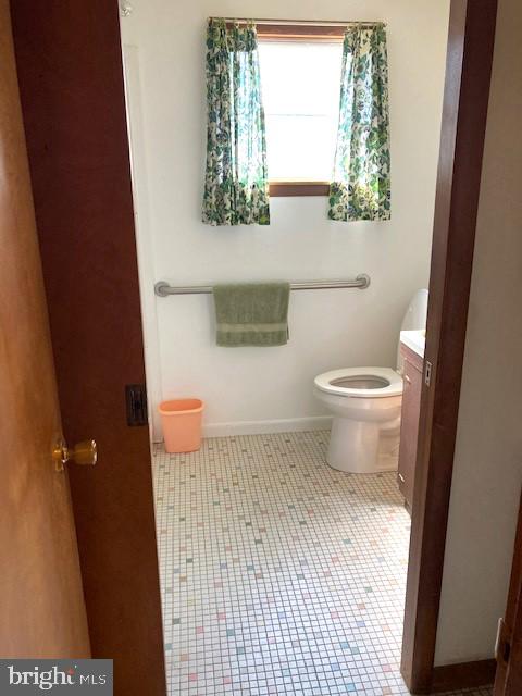 bathroom with tile patterned flooring, toilet, and vanity