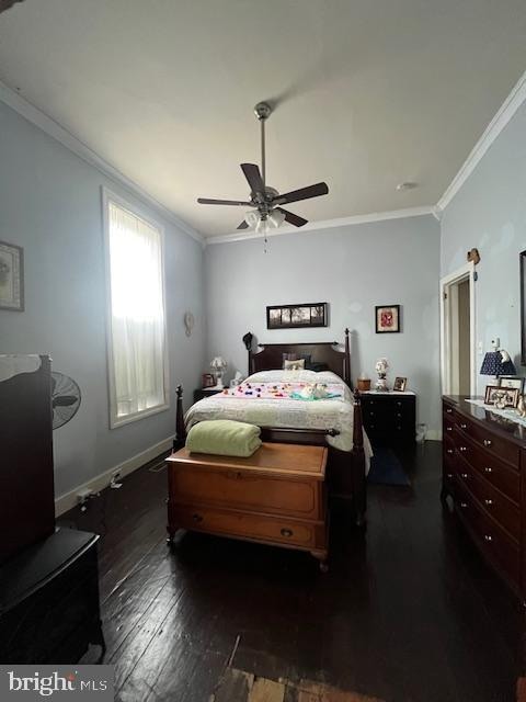 bedroom with ceiling fan, dark hardwood / wood-style floors, and crown molding