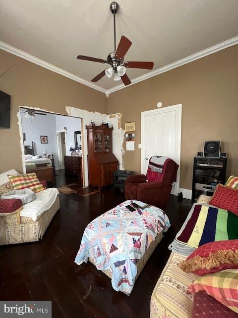 bedroom with ornamental molding, dark hardwood / wood-style flooring, and ceiling fan