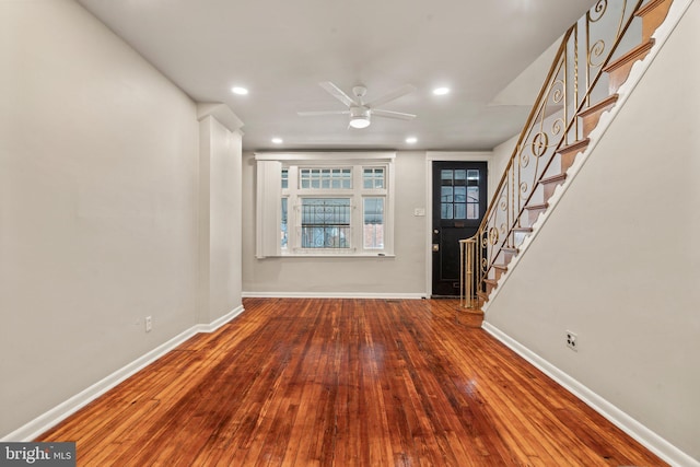 unfurnished living room with hardwood / wood-style floors and ceiling fan