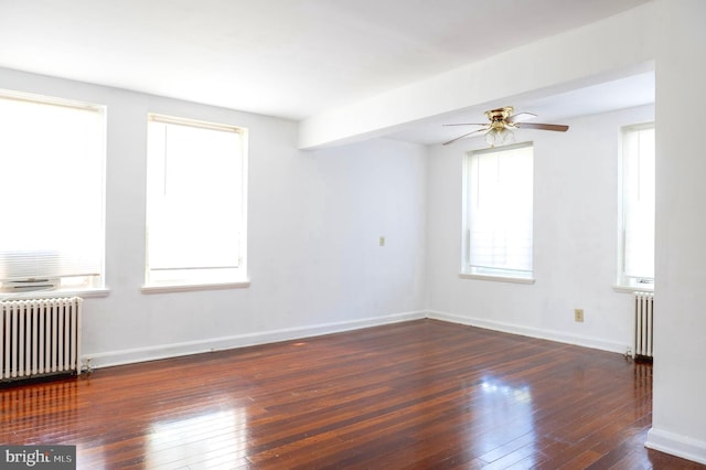 unfurnished room with ceiling fan, radiator, and dark hardwood / wood-style floors