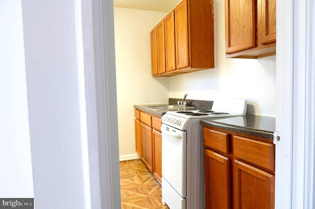 clothes washing area with washer and dryer, cabinets, and sink