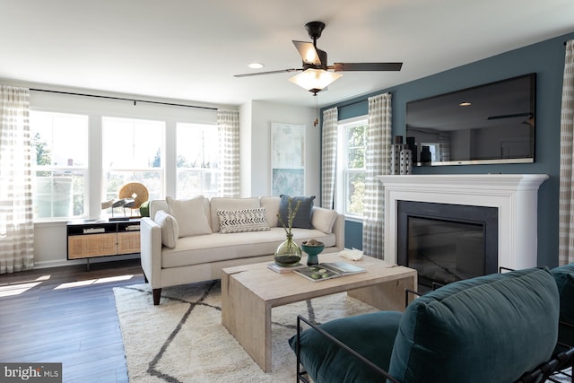 living room with light hardwood / wood-style flooring and ceiling fan