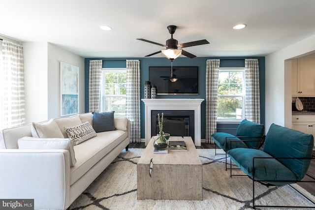 living room with light wood-type flooring and ceiling fan