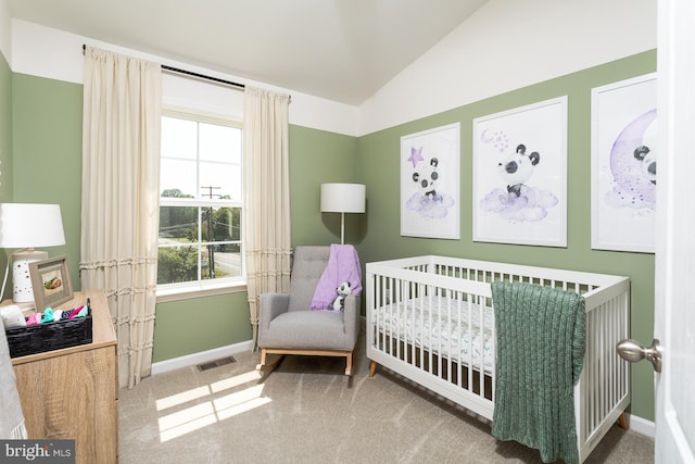 carpeted bedroom with a nursery area and vaulted ceiling