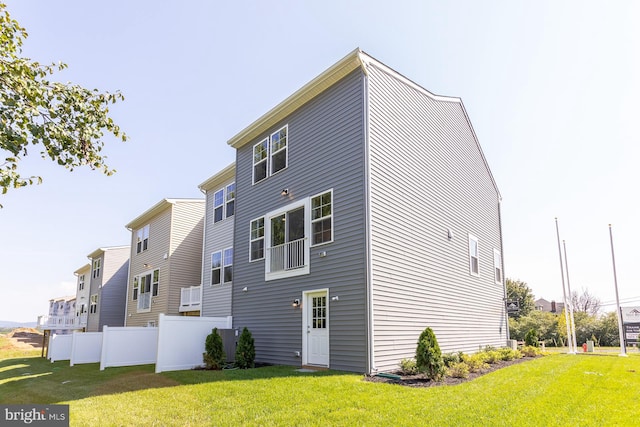 back of property featuring a lawn