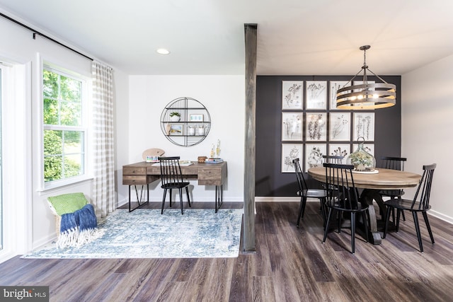 dining area with a chandelier and dark hardwood / wood-style flooring