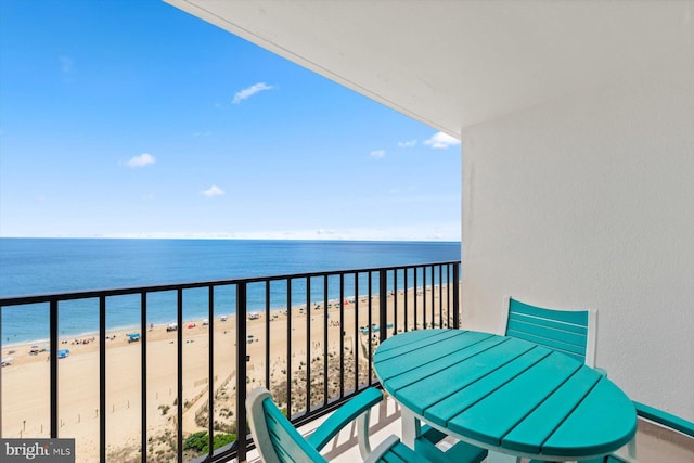 balcony with a water view and a beach view