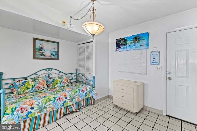 tiled bedroom with a closet