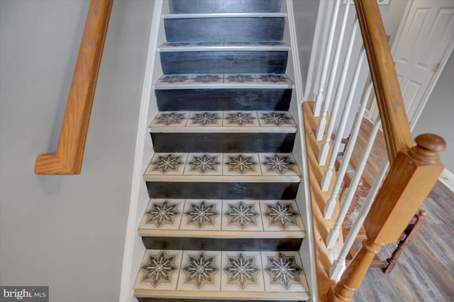 staircase with wood-type flooring