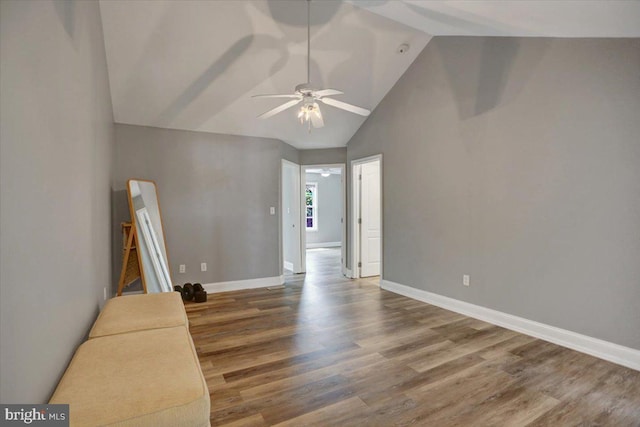 interior space with lofted ceiling, ceiling fan, and wood-type flooring