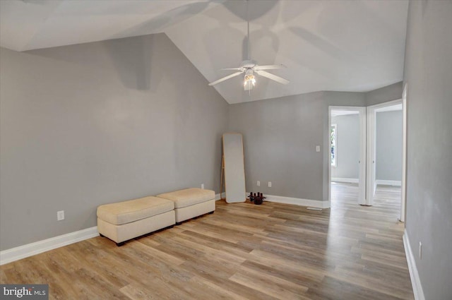 unfurnished room with ceiling fan, lofted ceiling, and light hardwood / wood-style floors