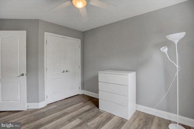 unfurnished bedroom featuring ceiling fan and hardwood / wood-style flooring