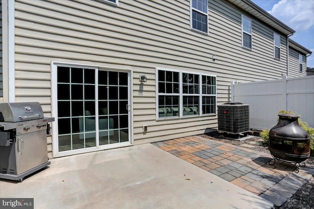 view of patio / terrace featuring a grill and cooling unit