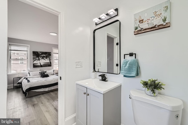 bathroom featuring hardwood / wood-style flooring, vanity, and toilet