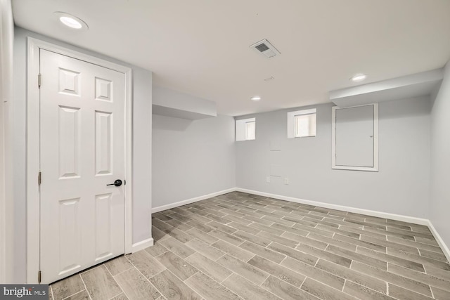 basement with light hardwood / wood-style flooring