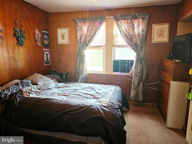 bedroom with cooling unit, carpet, and wood walls