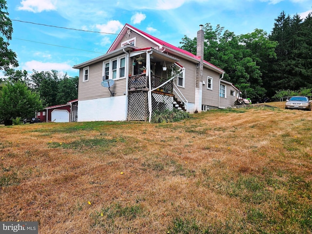 exterior space with a garage, a yard, and a porch