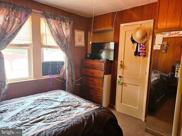 carpeted bedroom with cooling unit and wood walls