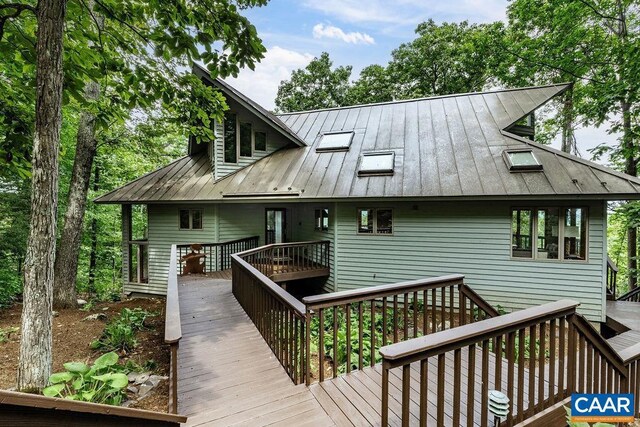 back of house featuring a deck