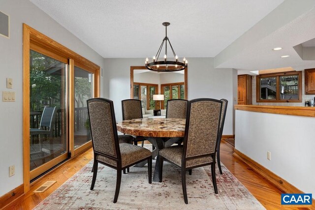 dining room featuring light hardwood / wood-style floors and a chandelier