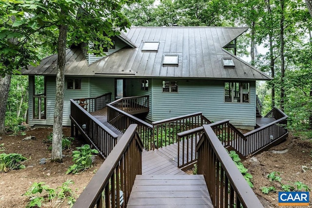 back of property featuring a wooden deck