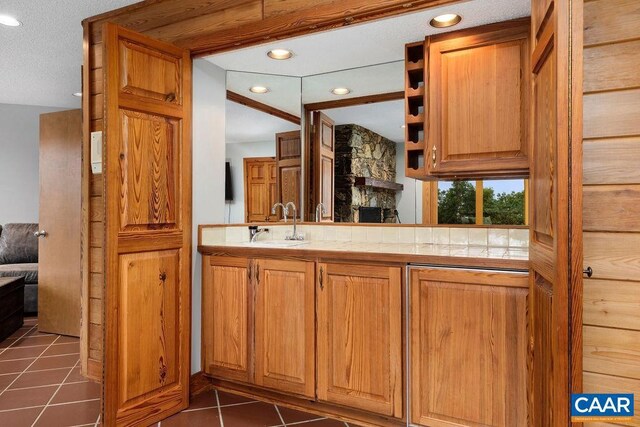 bathroom featuring vanity, tile patterned floors, and a textured ceiling