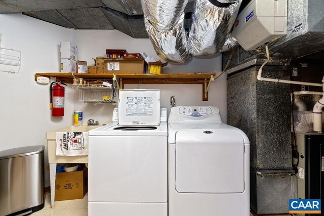 clothes washing area featuring independent washer and dryer and light tile patterned floors