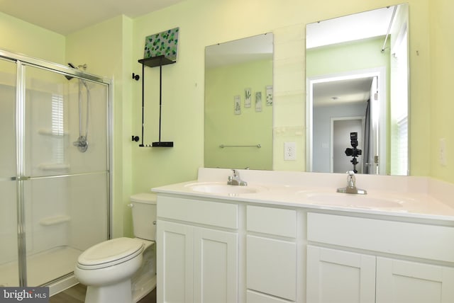 bathroom featuring walk in shower, vanity, and toilet