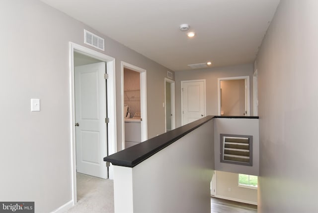 hall featuring washer / clothes dryer and carpet floors