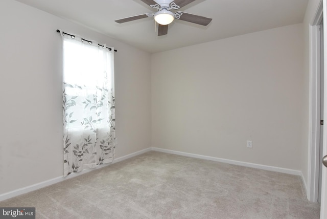 unfurnished room with light carpet and ceiling fan