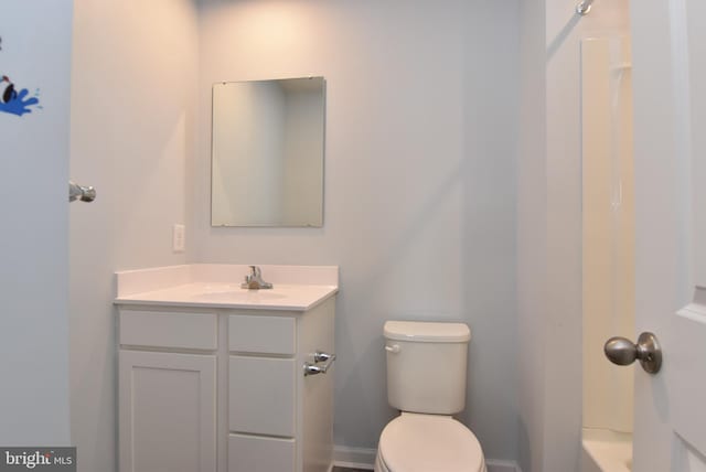 bathroom with vanity, toilet, and a bath