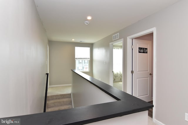 hallway with light colored carpet