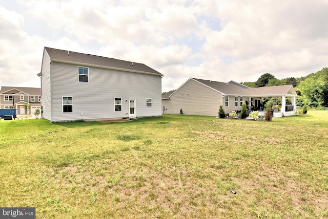 rear view of house with a yard