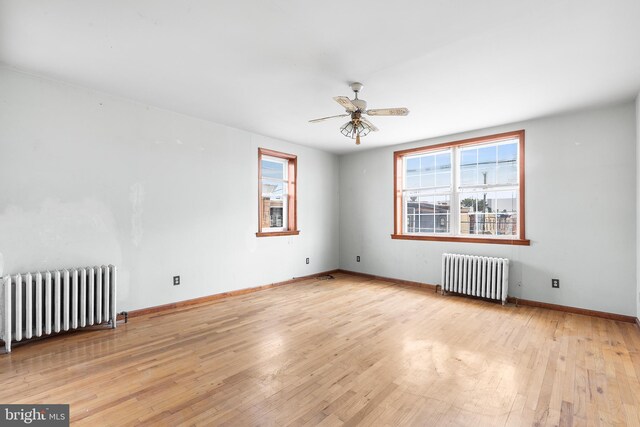 hallway with radiator and light hardwood / wood-style flooring