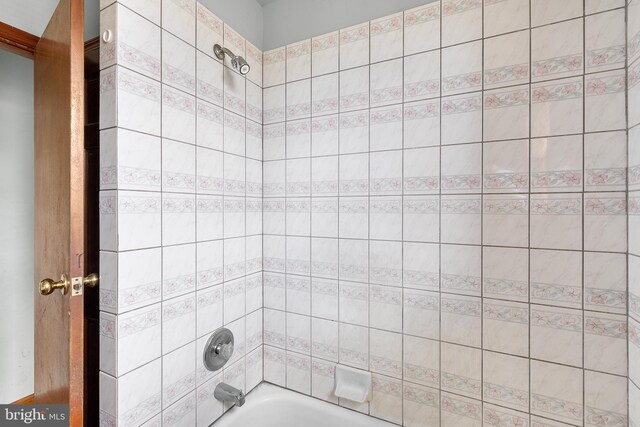 bathroom featuring toilet, tile patterned floors, tile walls, and double vanity