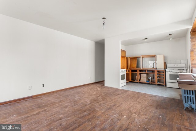 unfurnished living room featuring wood-type flooring