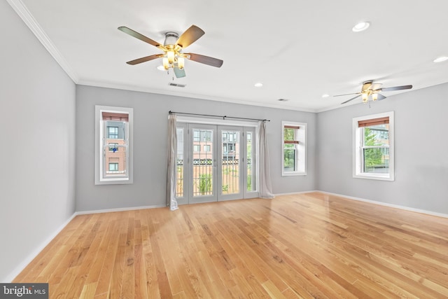 spare room with ceiling fan, light wood-type flooring, and ornamental molding