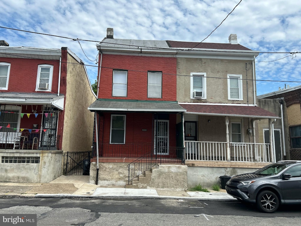 townhome / multi-family property with covered porch