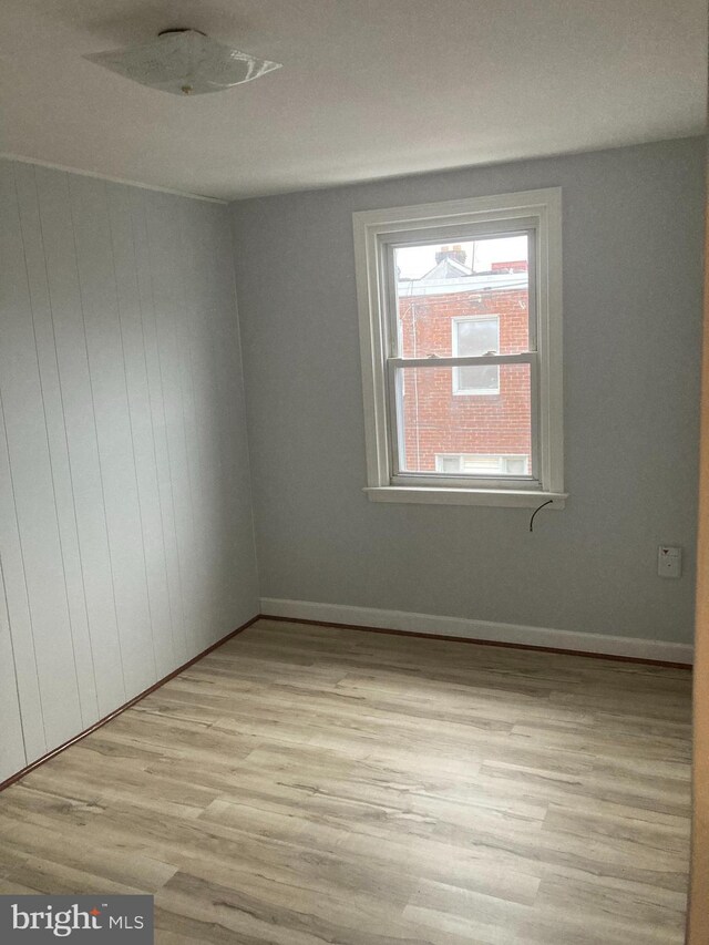 empty room with light hardwood / wood-style floors