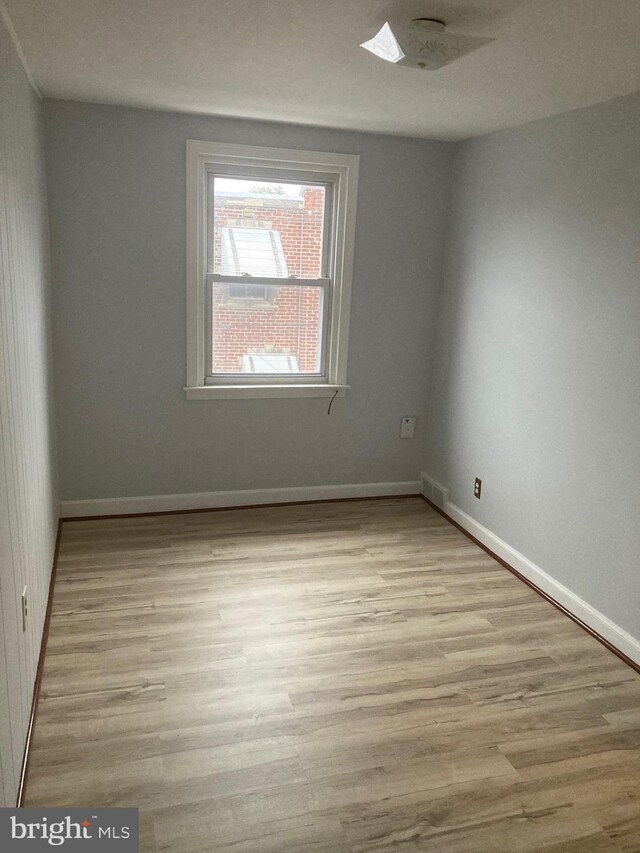 unfurnished room featuring light wood-type flooring