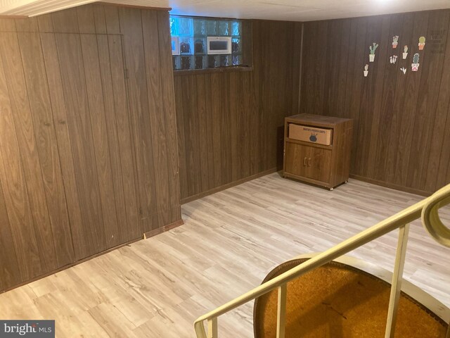 view of sauna / steam room featuring wood-type flooring and wooden walls