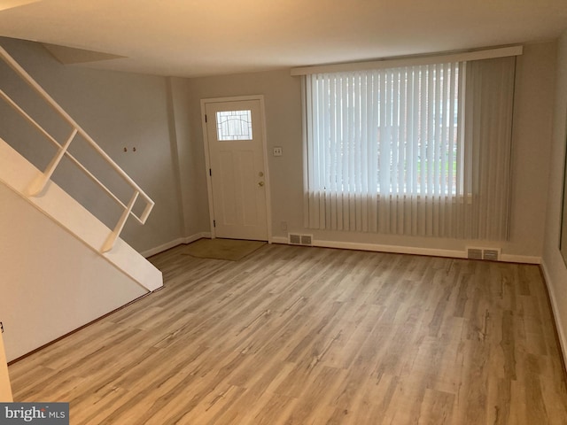 foyer entrance with light hardwood / wood-style flooring